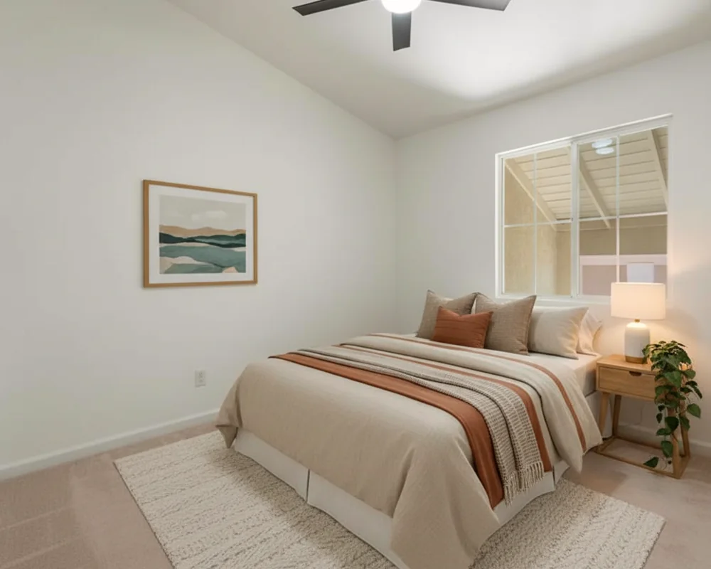 A warm, welcoming bedroom with a neatly made bed and soft light